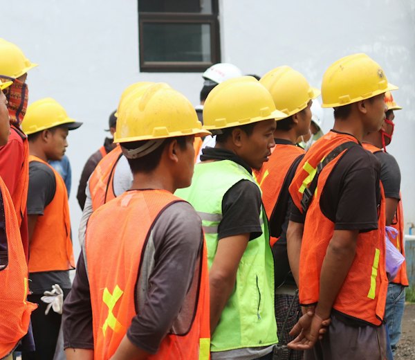 Group of workers in hard hats and safety vests