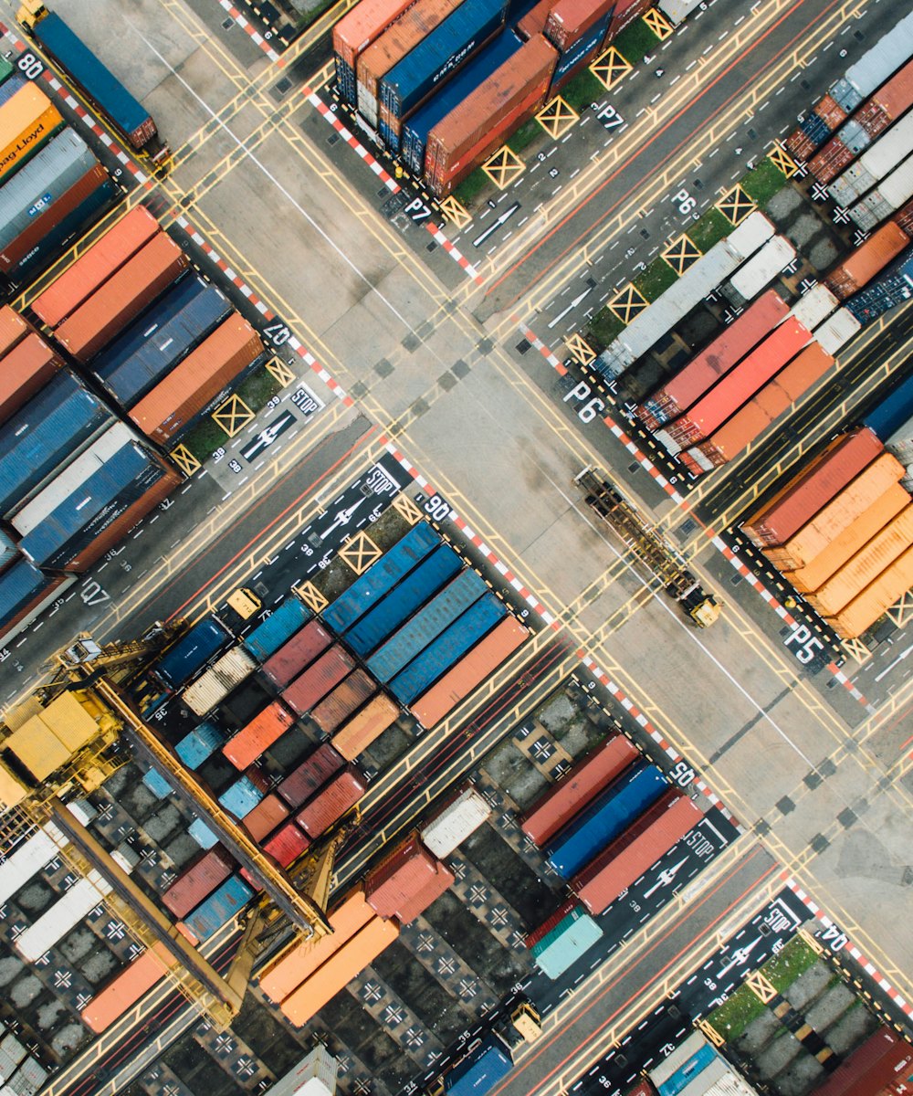 Aerial view of trucks moving through a shipping container yard