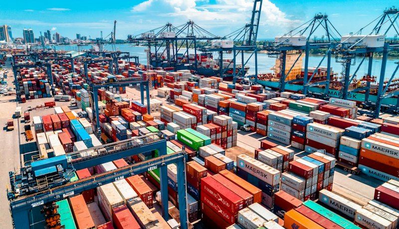 Port terminal stacked with colourful shipping containers
