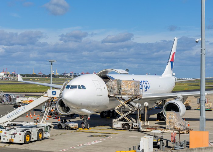 Cargo plane being loaded on an airport tarmac